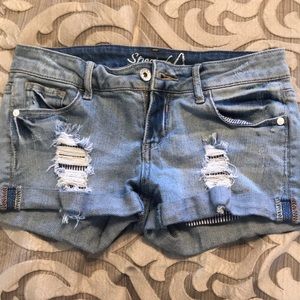Light colored ripped jean shorts